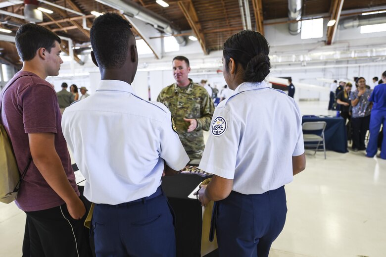 Members of Reserve Officers Training Corps. talk to a recruiter during the fourth annual New Mexico Aviation Aerospace Association Career Expo Oct. 6, 2016 at Holloman Air Force Base N.M. About 2,500 middle school through college-level students from across New Mexico came out to learn about the science, technology, engineering and mathematics fields. The goal of STEM is to motivate and educate students by giving them a taste of what aviation and aerospace engineering is all about. These STEM events also get the students talking to people who are working directly in STEM industries.  (U.S. Air Force photo by Staff Sgt. Stacy Jonsgaard)