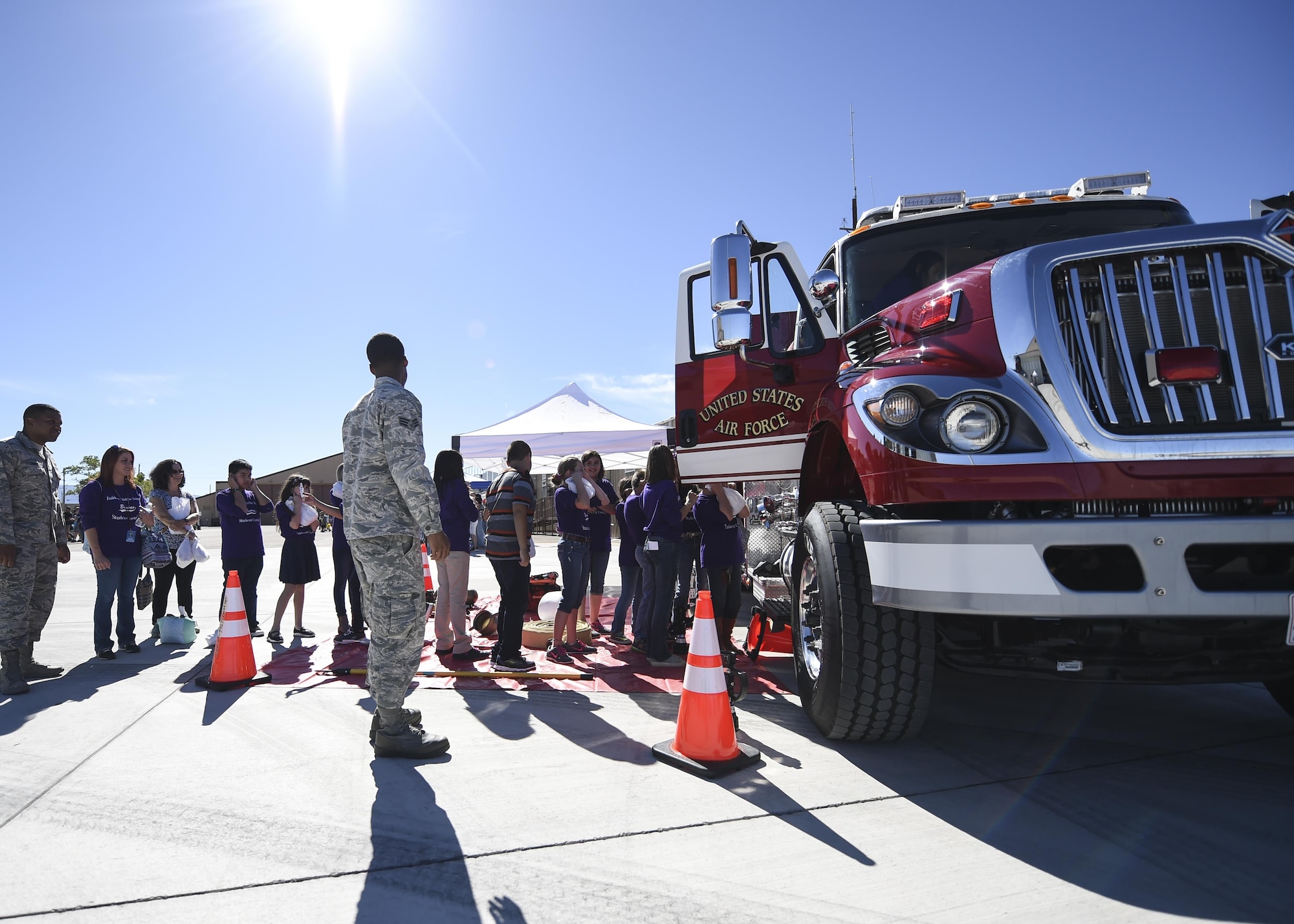 Fire Fighters from the 49th Civil Engineer squadron show children a fire truck during the fourth annual New Mexico Aviation Aerospace Association Career Expo Oct. 6, 2016 at Holloman Air Force Base N.M. About 2,500 middle school through college-level students from across New Mexico came out to learn about the science, technology, engineering and mathematics fields. The goal of STEM is to motivate and educate students by giving them a taste of what aviation and aerospace engineering is all about. These STEM events also get the students talking to people who are working directly in STEM industries.  (U.S. Air Force photo by Staff Sgt. Stacy Jonsgaard)