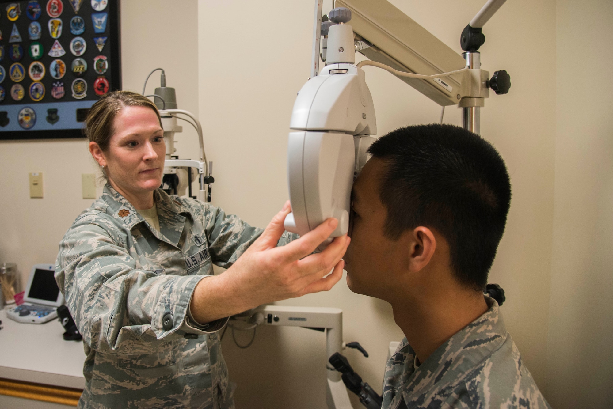 Maj. Kerry Phelan, 375th Aerospace Medicine optometry flight commander, performs an eye exam at the 375th Medical Group optometry department. Phelan will be awarded the overall Armed Forces Optomtrey Society Junior Optometrist of the Year 2016 on Nov. 8at the AFOS annual meeting in Anaheim, CA.  (U.S. Air Force Photo by Airman 1st Class Daniel Garcia)