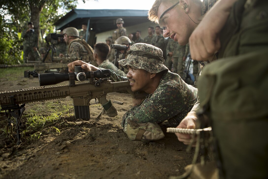 Marine Corps Cpl. Alec Milejczak, right, shows a Philippine marine how to use an M110 semiautomatic sniper rifle during Philippine Amphibious Landing Exercise 33 at Colonel Ernesto Ravina Air Base, Philippines, Oct. 7, 2016. The annual U.S.-Philippine military bilateral exercise combines amphibious capabilities and live-fire training with humanitarian assistance efforts. Marine Corps photo by Lance Cpl. Jesula Jeanlouis