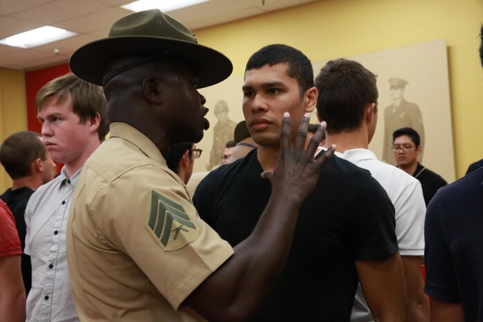 Sergeant Justin J. Harrison, drill instructor, Receiving Company, Support Battalion, instructs a recruit to yell louder during receiving at Marine Corps Recruit Depot San Diego, Oct. 11. While recruits are on the depot, they will have drill instructor supervising them every day, everywhere they go. Annually, more than 17,000 males recruited from the Western Recruiting Region are trained at MCRD San Diego. Charlie Company is scheduled to graduate Jan. 6.