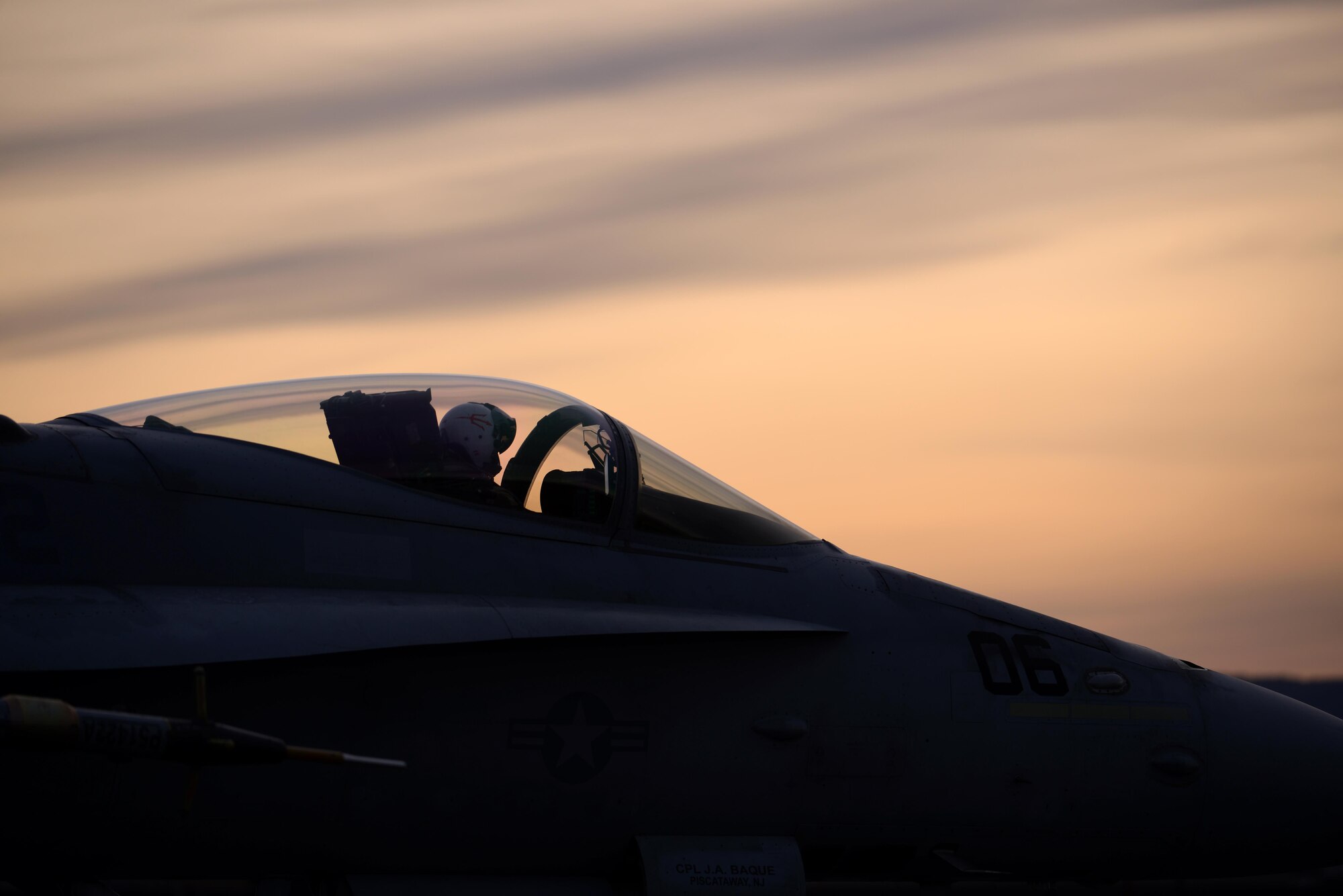 A pilot assigned to Marine Fighter Attack Squadron 232 out of Marine Corps Air Station Miramar, Calif., taxis his F/A-18C Hornet aircraft down the Eielson Air Force Base, Alaska, flight line as the sun rises Oct. 10, 2016, during RED FLAG-Alaska (RF-A) 17-1. The Joint Pacific Alaska Range Complex provides more than 67,000 square miles of realistic training environment and allows commanders to train for full spectrum engagements, ranging from individual skills to complex, large-scale joint engagements. (U.S. Air Force photo by Master Sgt. Karen J. Tomasik)