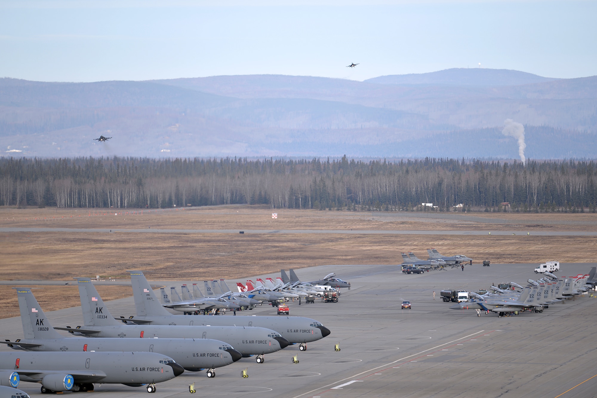 A variety of units aircraft and personnel, including U.S. Marine Corps F/A-18C Hornet aircraft and personnel from Marine Fighter Attack Squadron 232 out of Marine Corps Air Station Miramar, Calif., gather in their ramp space as a pair of U.S. Air Force F-16 Fighting Falcon aircraft assigned to the 36th Fighter Squadron out of Osan Air Base, Republic of Korea, prepare to land at Eielson Air Force Base, Alaska, Oct. 10, 2016, after the first RED FLAG-Alaska (RF-A) 17-1 combat training mission. Pacific Air Forces commander-directed field training exercises like RF-A are vital to maintaining peace and stability in the Indo-Asia-Pacific region. (U.S. Air Force photo by Master Sgt. Karen J. Tomasik)