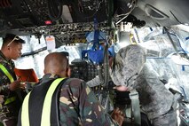 U.S. Air Force Tech. Sgt. Devon Blue (right), 18th Expeditionary Airlift Squadron fire protection specialist, facilitates discussion on flight line firefighting operations with members of the Philippine Air Force and Philippine Federal Aviation Administration firefighters next to a U.S. Air Force C-130 Hercules during a subject matter expert exchange as part of the current iteration of U.S. Pacific Command’s Air Contingent at Brigadier General Benito N Ebuen Air Base, Lapu-Lapu City, Philippines, Sept. 26, 2016. The Air Contingent is helping build the capacity of the Philippine Air Force and increases joint training, promotes interoperability and provides greater and more transparent air and maritime situational awareness to ensure safety for military and civilian activities in international waters and airspace. Its missions include air and maritime domain awareness, personnel recovery, combating piracy, and assuring access to the air and maritime domains in accordance with international law. (U.S. Air Force photo by Capt. Mark Lazane)