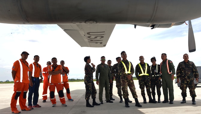 Philippine Air Force and civilian Federal Aviation Administration firefighters await under the wing of a U.S. Air Force C-130 Hercules for their turn to receive instruction on flight deck engine shutdown procedures from U.S. Air Force fire protection specialists during a subject matter expert exchange as part of the current iteration of U.S. Pacific Command’s Air Contingent at Brigadier General Benito N Ebuen Air Base, Lapu-Lapu City, Philippines,  Sept. 26, 2016. The Air Contingent is helping build the capacity of the Philippine Air Force and increases joint training, promotes interoperability and provides greater and more transparent air and maritime situational awareness to ensure safety for military and civilian activities in international waters and airspace. Its missions include air and maritime domain awareness, personnel recovery, combating piracy, and assuring access to the air and maritime domains in accordance with international law. (U.S. Air Force photo by Capt. Mark Lazane)