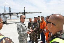 U.S. Air Force Tech. Sgt. Devon Blue (left), 18th Expeditionary Airlift Squadron fire protection specialist, facilitates discussion on flight line firefighting operations with members of the Philippine Air Force and Philippine Federal Aviation Administration firefighters next to a U.S. Air Force C-130 Hercules during a subject matter expert exchange as part of the current iteration of U.S. Pacific Command’s Air Contingent at Brigadier General Benito N Ebuen Air Base, Lapu-Lapu City, Philippines, Sept. 26, 2016. The Air Contingent is helping build the capacity of the Philippine Air Force and increases joint training, promotes interoperability and provides greater and more transparent air and maritime situational awareness to ensure safety for military and civilian activities in international waters and airspace. Its missions include air and maritime domain awareness, personnel recovery, combating piracy, and assuring access to the air and maritime domains in accordance with international law. (U.S. Air Force photo by Capt. Mark Lazane)