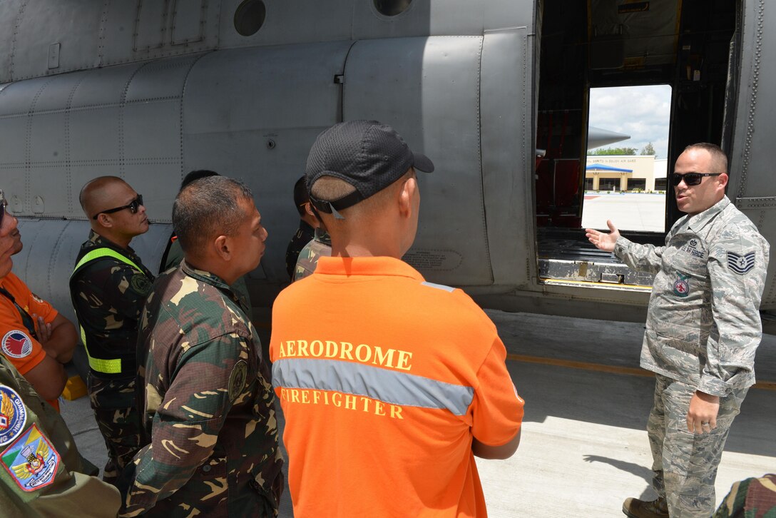 U.S. Air Force Tech. Sgt. Devon Blue, 18th Expeditionary Airlift Squadron fire protection noncommissioned officer in charge, facilitates discussion on flight line firefighting operations with members of the Philippine Air Force and Philippine Federal Aviation Administration firefighters next to a U.S. Air Force C-130 Hercules during a subject matter expert exchange as part of the current iteration of U.S. Pacific Command’s Air Contingent at Brigadier General Benito N Ebuen Air Base, Lapu-Lapu City, Philippines, Sept. 26, 2016. The Air Contingent is helping build the capacity of the Philippine Air Force and increases joint training, promotes interoperability and provides greater and more transparent air and maritime situational awareness to ensure safety for military and civilian activities in international waters and airspace. Its missions include air and maritime domain awareness, personnel recovery, combating piracy, and assuring access to the air and maritime domains in accordance with international law. (U.S. Air Force photo by Capt. Mark Lazane)