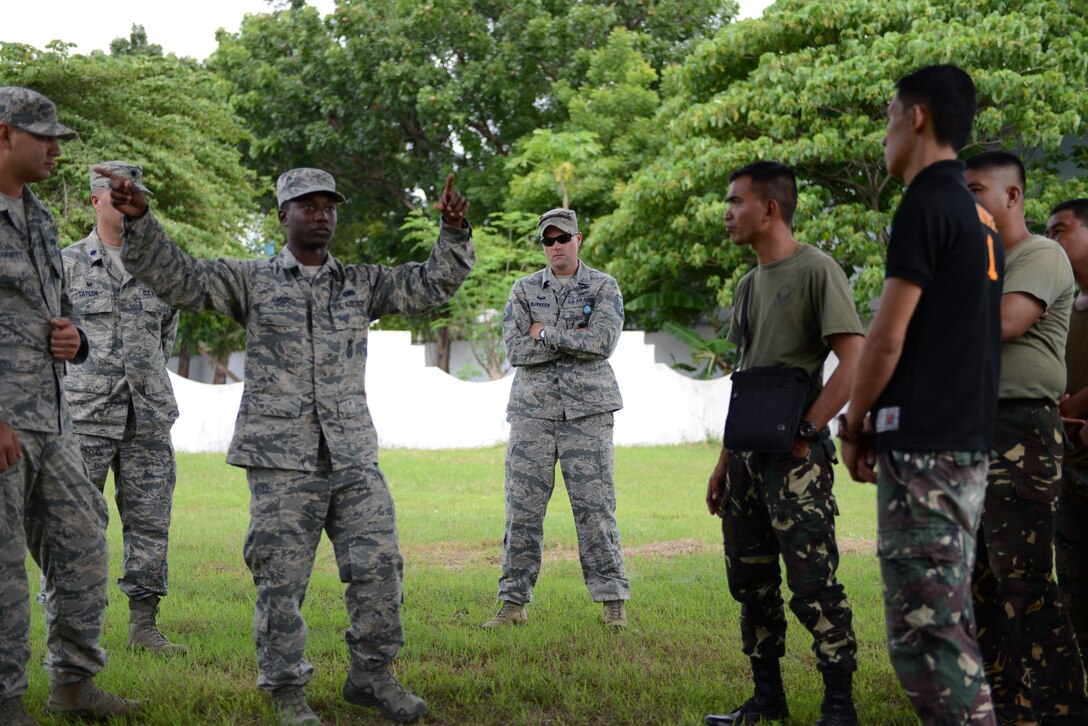 U.S. Air Force Senior Airman Mikavion Hagood, 18th Expeditionary Airlift Squadron security forces member, discusses United States best practices to defend an airplane from an aggressor with his Philippine Air Force counterparts during a subject matter expert exchange as part of the current iteration of U.S. Pacific Command’s Air Contingent at Brigadier General Benito N Ebuen Air Base, Lapu-Lapu City, Philippines, Oct. 3, 2016. The Air Contingent is helping build the capacity of the Philippine Air Force and increases joint training, promotes interoperability and provides greater and more transparent air and maritime situational awareness to ensure safety for military and civilian activities in international waters and airspace. Its missions include air and maritime domain awareness, personnel recovery, combating piracy, and assuring access to the air and maritime domains in accordance with international law. (U.S. Air Force photo by Capt. Mark Lazane)