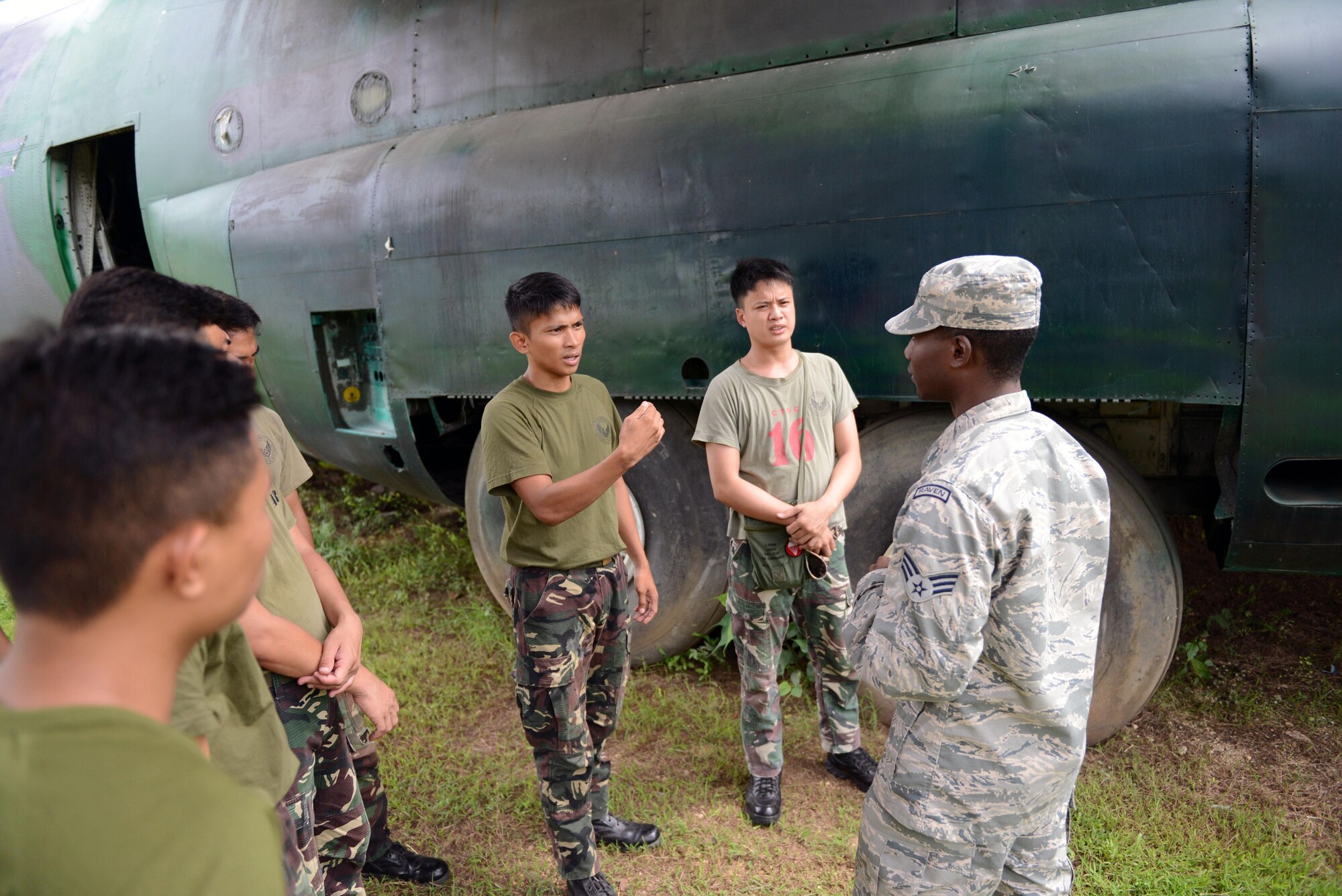 U.S. Air Force Senior Airman Mikavion Hagood, 18th Expeditionary Airlift Squadron security forces member, discusses best practices to defend an airplane from an aggressor with his Philippine Air Force counterparts during a subject matter expert exchange as part of the current iteration of  U.S. Pacific Command’s  Air Contingent at Brigadier General Benito N Ebuen Air Base, Lapu-Lapu City, Philippines, Oct. 3, 2016. The Air Contingent is helping build the capacity of the Philippine Air Force and increases joint training, promotes interoperability and provides greater and more transparent air and maritime situational awareness to ensure safety for military and civilian activities in international waters and airspace. Its missions include air and maritime domain awareness, personnel recovery, combating piracy, and assuring access to the air and maritime domains in accordance with international law. (U.S. Air Force photo by Capt. Mark Lazane)