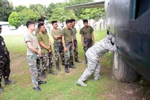 U.S. Air Force Senior Airman Mikavion Hagood, 18th Expeditionary Airlift Squadron security forces member, discusses best practices for inspecting an airplane while performing airfield security duties with his Philippine Air Force counterparts during a subject matter expert exchange as part of the current iteration of U.S. Pacific Command’s Air Contingent at Brigadier General Benito N Ebuen Air Base, Lapu-Lapu City, Philippines, Oct. 3, 2016. The Air Contingent is helping build the capacity of the Philippine Air Force and increases joint training, promotes interoperability and provides greater and more transparent air and maritime situational awareness to ensure safety for military and civilian activities in international waters and airspace. Its missions include air and maritime domain awareness, personnel recovery, combating piracy, and assuring access to the air and maritime domains in accordance with international law. (U.S. Air Force photo by Capt. Mark Lazane)