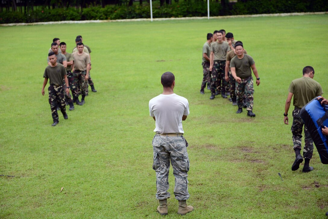 U.S. Air Force Staff Sgt. Antoine Dunlap, 18th Expeditionary Airlift Squadron security forces member, discusses best practices regarding nonlethal means of subduing an aggressor with his Philippine Air Force counterparts during a subject matter expert exchange as part of the current iteration of U.S. Pacific Command’s Air Contingent at Brigadier General Benito N Ebuen Air Base, Lapu-Lapu City, Philippines, Oct. 4, 2016. The Air Contingent is helping build the capacity of the Philippine Air Force and increases joint training, promotes interoperability and provides greater and more transparent air and maritime situational awareness to ensure safety for military and civilian activities in international waters and airspace. Its missions include air and maritime domain awareness, personnel recovery, combating piracy, and assuring access to the air and maritime domains in accordance with international law. (U.S. Air Force photo by Capt. Mark Lazane)