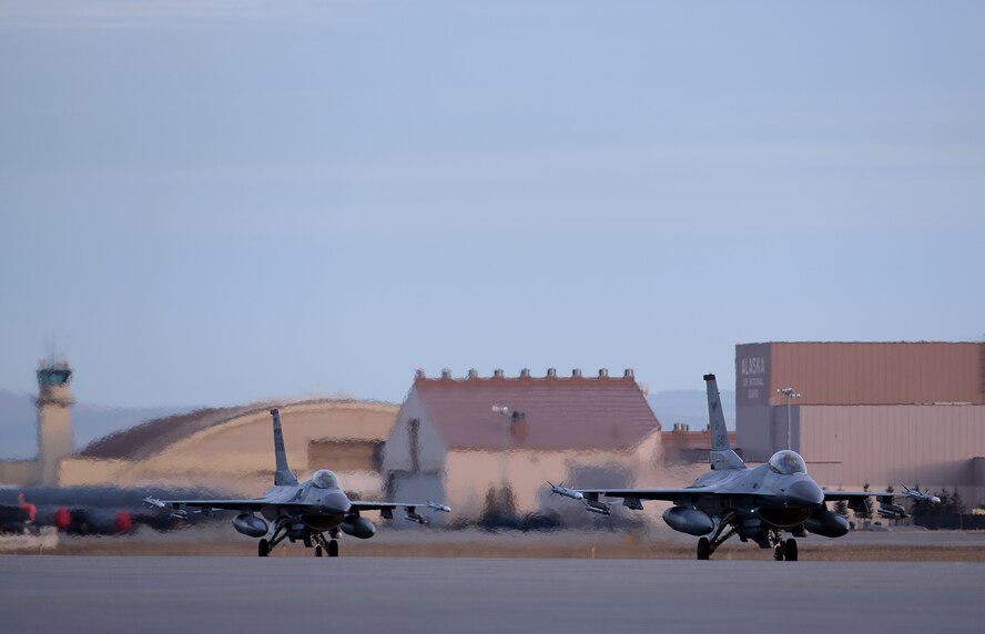 A pair of U.S. Air Force F-16 Fighting Falcons assigned to the 36th Fighter Squadron out of Osan Air Base, Republic of Korea, taxi down the Eielson Air Force Base, Alaska, flight line Oct. 10, 2016, during RED FLAG-Alaska (RF-A) 17-1. Conducting RED FLAG training in Alaska signifies a continued commitment to the Pacific, providing U.S. and international units the opportunity to sharpen their combat skills and strengthen interoperability in a realistic threat environment inside the Joint Pacific Alaska Range Complex, the largest instrumented air, ground and electronic combat training range in the world. (U.S. Air Force photo by Master Sgt. Karen J. Tomasik)