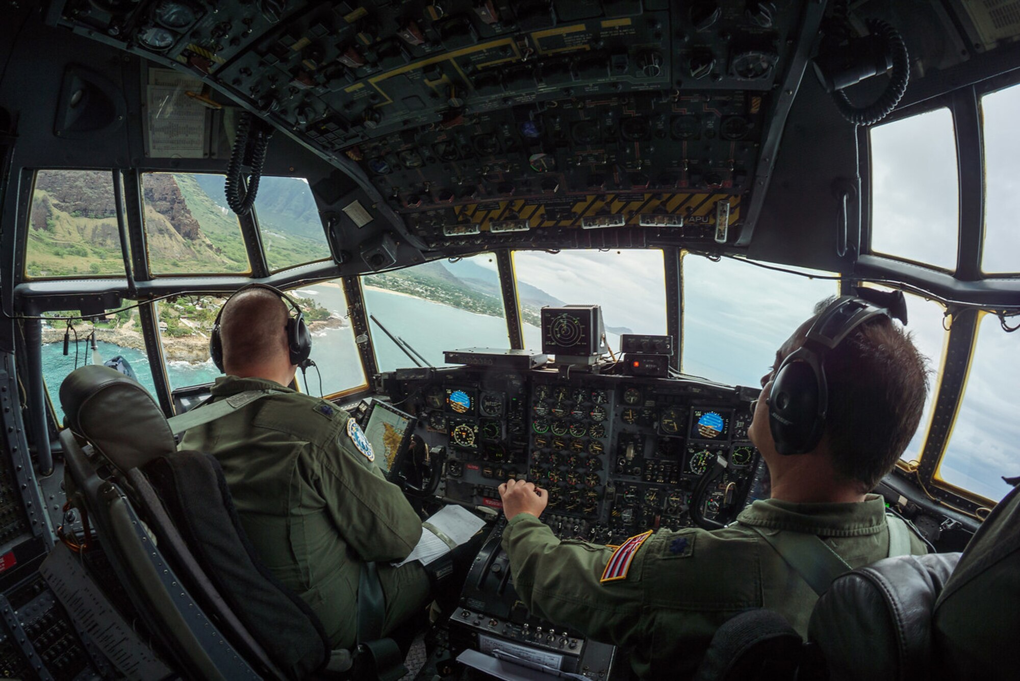 An aircrew from the Kentucky Air National Guard's 165th Airlift Squadron banks a C-130 Hercules over one of the islands of Hawaii during exercise Sentry Aloha Aug. 23, 2016. The Kentucky Air National Guard and multiple other Air Guard units took part in the exercise, which tested multiple airframes and aircrews in wartime scenarios. (U.S. Air National Guard photo by Senior Airman Robert Buchberger)