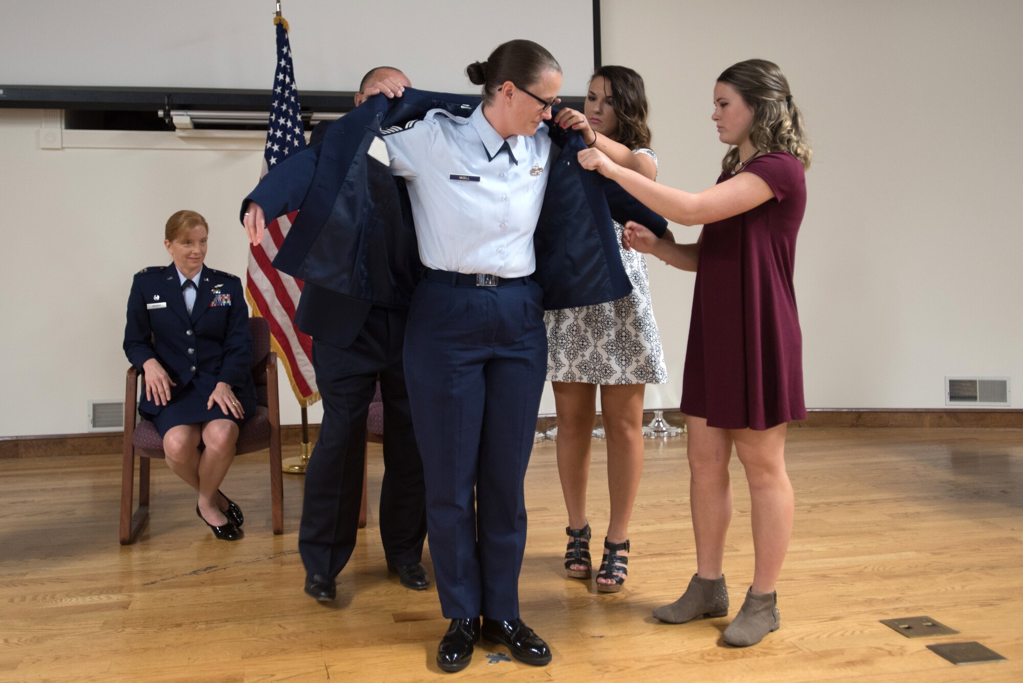 Senior Master Sgt. Andrea Mizell, incoming chief enlisted manager for the 123rd Communication Flight, is promoted to the rank of chief master sergeant with some assistance from her family in a ceremony at the Kentucky Air National Guard base in Louisville, Ky., Sept. 17, 2016. (U.S. Air National Guard photo by Staff Sgt. Joshua Horton)
