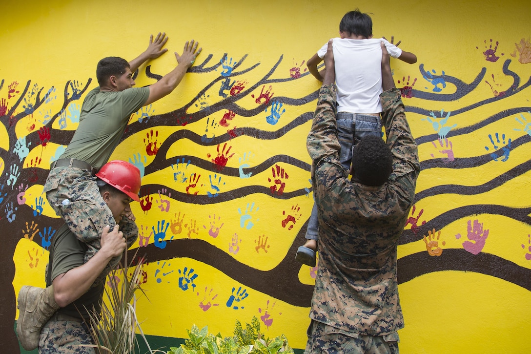 Marines and students put handprints on an elementary school wall restored during Philippine Amphibious Landing Exercise 33 in Cagayan Valley, Philippines, Oct. 10, 2016. The Marines are assigned to Bravo Company, 9th Engineer Support Battalion, 3rd Marine Logistics Group, 3rd Marine Expeditionary Force. Marine Corps photo by Cpl. Allison Lotz

