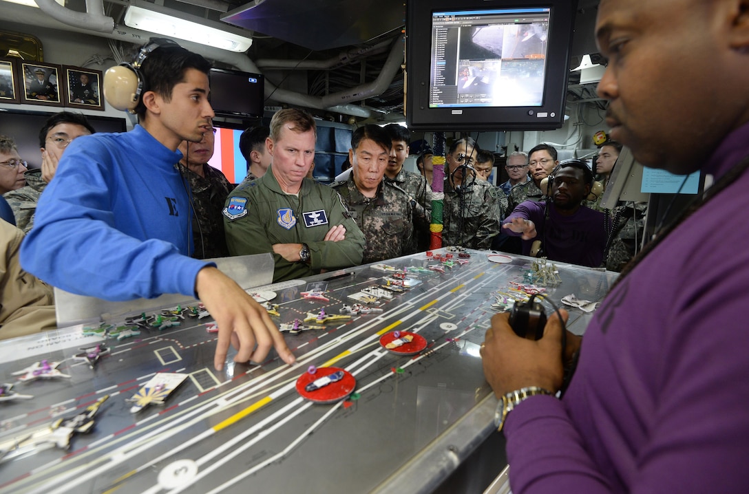 (Center) Lieutenant General Thomas Bergeson, U.S. Forces Korea deputy commander, and Gen. Leem, Ho Young, Combined Forces Command deputy commander, observe an operational briefing aboard the USS Ronald Reagan (CVN
76) during the Invincible Spirit exercise Oct. 13. 
