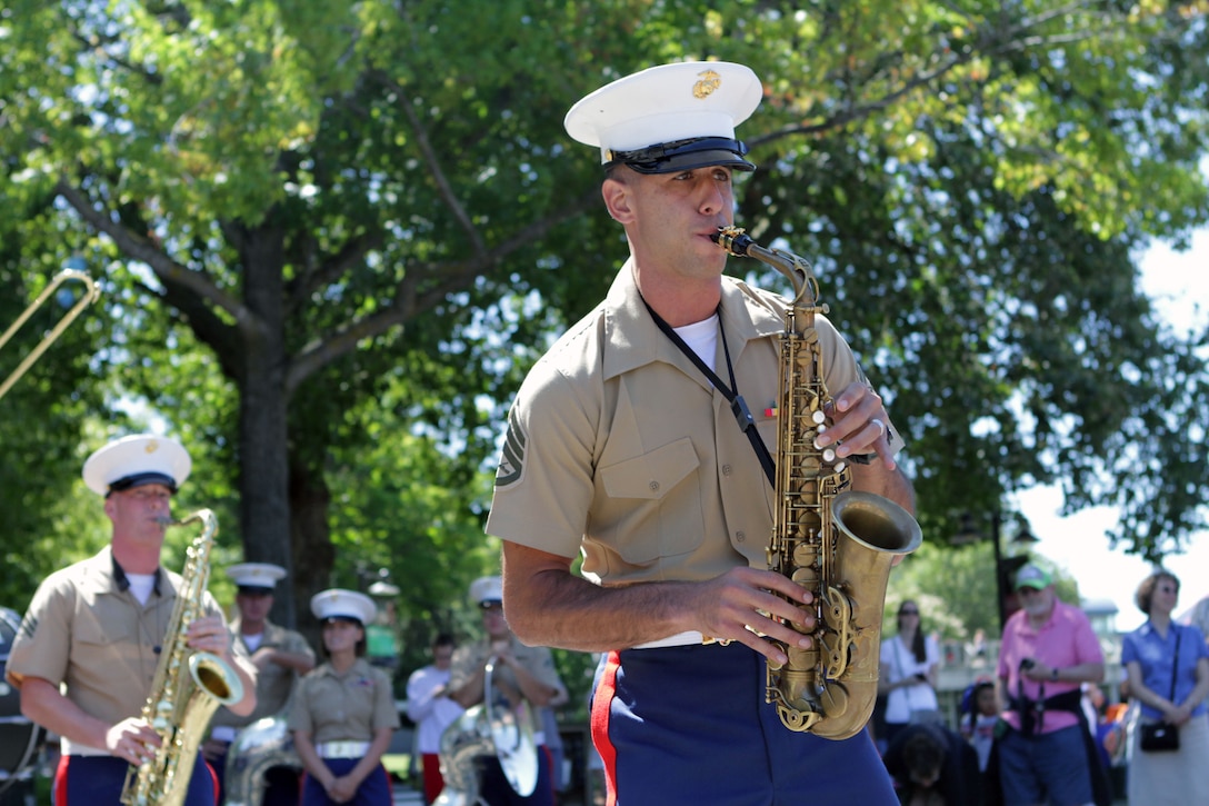 Staff Sergeant Mark A. Pellon, a musician with the 3rd Marine Aircraft Wing Band and a resident of Miami, conducts a solo during a performance by the band at the Seattle Center July 27, during Marine Week Seattle 2014. Marine Week Seattle showcases Marine Corps equipment, aircraft and technological capabilities to the general public. More than 700 Marines are participating in Marine Week Seattle to give Seattleites the opportunity to meet the individual Marine and celebrate community, country and Corps. (U.S. Marine Corps photo by Cpl. Brandon Suhr/Released) 
