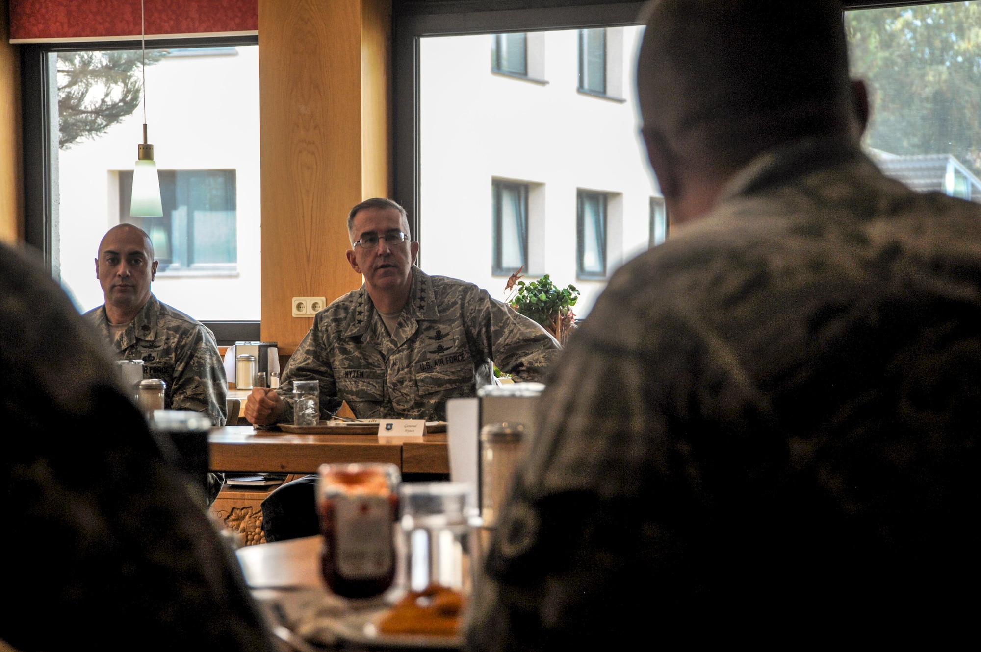 General John E. Hyten, Air Force Space Command commander, and Maj. Michael J. Hurley, 691st Cyberspace Operations Squadron commander, listen to a question posed by a 691st COS Airman at Ramstein Air Base, Germany, Oct. 4, 2016. Hyten visited the 691st COS, which was recently realigned under AFSPC. During his visit, Hyten had lunch with Airmen from the 691st COS, where they were able to ask him questions. (U.S. Air Force photo by Staff Sgt. Timothy Moore)
