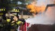 Airman 1st Class Austyn Helgeson and Senior Airman Scott Burdick, 11th Wing Civil Engineer firefighters, put out a fire during a live fire exercise at Joint Base Andrews, Md., Oct. 7, 2015. The exercise was part of the fire prevention week on JBA. (U.S. Air Force photo by Airman 1st Class Philip Bryant/Released)