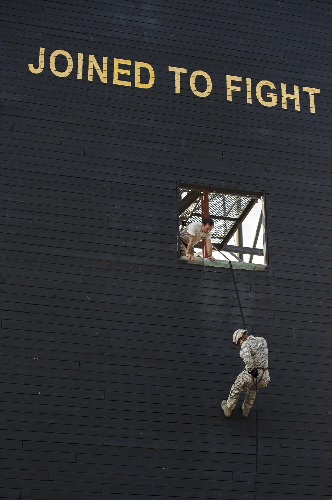 Tech. Sgt. Matthew Meade, 820th Combat Operations Squadron NCO in charge future operations, watches as Tech. Sgt. Brandon Arroyo, 105th Base Defense Squadron squad leader, rappels during training, Sept. 29, 2016, at Moody Air Force Base, Ga. The 820th Base Defense Group was able to use its post-deployment experience and training resources to help train the Air National Guardsmen of the 105th BDS. (U.S. Air Force photo by Tech. Sgt. Zachary Wolf)
