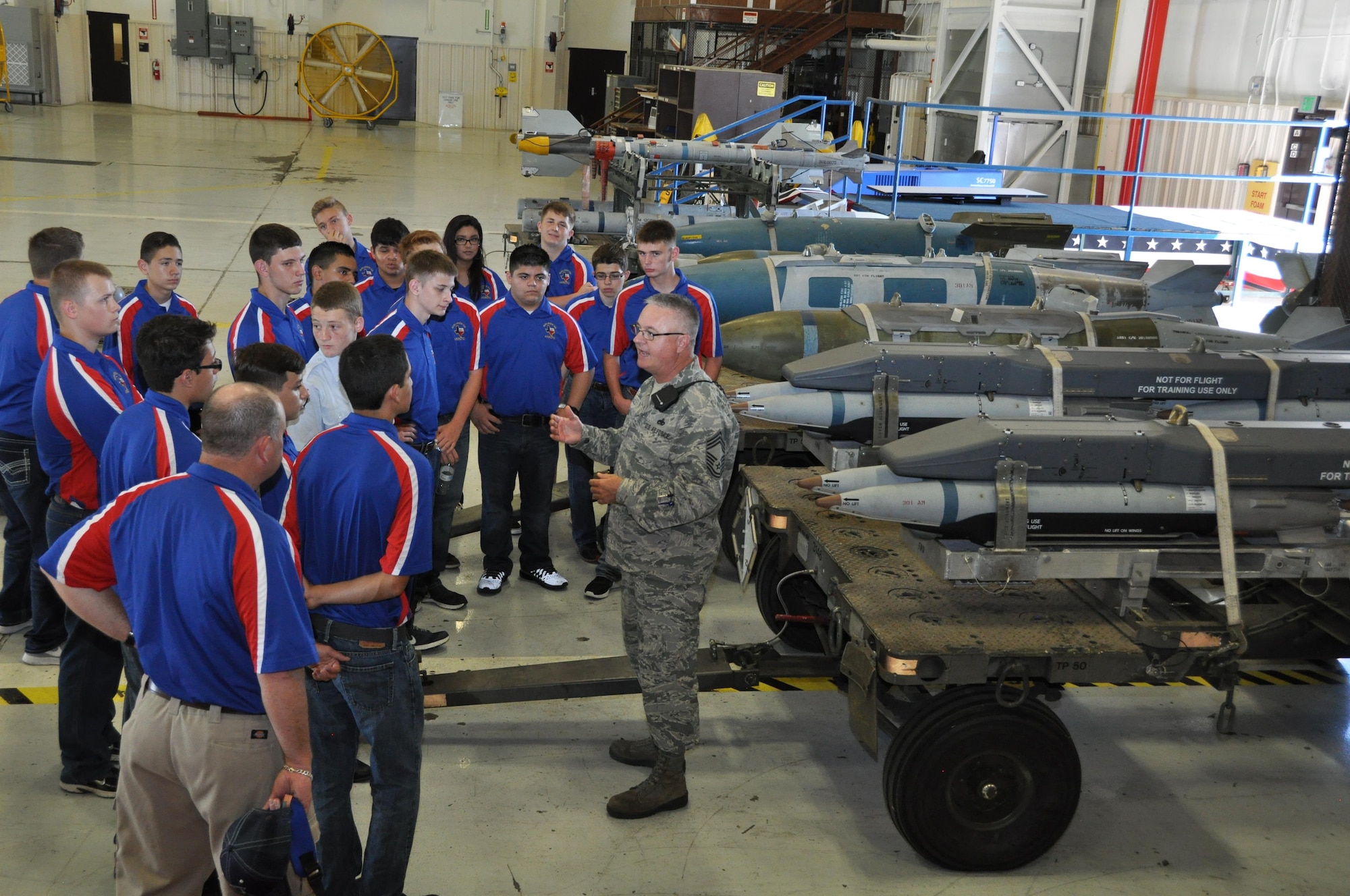 Chief Master Sgt. Tod Bell, 301st Aircraft Maintenance Squadron's superintendent, provides an overview of the munitions used on an F-16 Fighting Falcon to Junior Reserve Officer Training cadets during a tour around Naval Air Station Fort Worth Joint Reserve Base, Texas, Oct. 5, 2016. Forty-two cadets from Burleson high school explored the 301st Civil Engineer Squadron Explosive Ordnance Disposal demonstration, the Army Bravo Company 90th Aviation Support Battalion’s Black Hawk helicopter, the base control tower and its radar site. (U.S. Air Force photo by Julie Briden-Garcia)