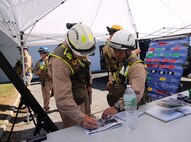 Capt. Zacharias G. Dentes, Reaction Force Company executive officer and Initial Response Force, IRF, B commander, left, and Master Sgt. Richard T. Ho, Technical Rescue Platoon team leader and emergency safety officer for IRF B, right, formulate a plan to respond to a notional steam plant explosion as part of a final training exercise with the Fire Department of New York, FDNY, on Randall’s Island, N.Y., Sept. 15, 2016. CBIRF’s Marines and sailors participated in a training event that included three days of lane training with FDNY instructors teaching classes in vehicle extrication, breaching, rope rescue and medical as part of urban rescue operations, and a final training operation in which CBIRF responded to a notional steam plant explosion. (Official U.S. Marine Corps photo by Lance Cpl. Maverick S. Mejia/RELEASED)
