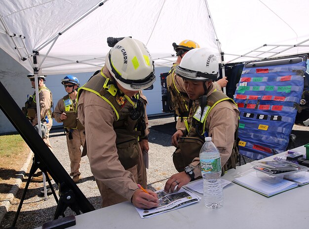 Capt. Zacharias G. Dentes, Reaction Force Company executive officer and Initial Response Force, IRF, B commander, left, and Master Sgt. Richard T. Ho, Technical Rescue Platoon team leader and emergency safety officer for IRF B, right, formulate a plan to respond to a notional steam plant explosion as part of a final training exercise with the Fire Department of New York, FDNY, on Randall’s Island, N.Y., Sept. 15, 2016. CBIRF’s Marines and sailors participated in a training event that included three days of lane training with FDNY instructors teaching classes in vehicle extrication, breaching, rope rescue and medical as part of urban rescue operations, and a final training operation in which CBIRF responded to a notional steam plant explosion. (Official U.S. Marine Corps photo by Lance Cpl. Maverick S. Mejia/RELEASED)
