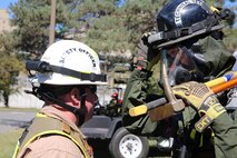 Staff Sgt. Justin Wells, safety officer for Initial Response Force, IRF, B, Chemical Biological Incident Response Force, CBIRF, left, examines a Technical Rescue Platoon Marine before heading into the “hot zone” for proper personal protective gear as part of a final training exercise with the Fire Department of New York, FDNY, on Randall’s Island, N.Y., Sept. 15, 2016. CBIRF’s Marines and sailors participated in a training event that included three days of lane training with FDNY instructors teaching classes in vehicle extrication, breaching, rope rescue and medical as part of urban rescue operations, and a final training operation in which CBIRF responded to a notional steam plant explosion. (Official U.S. Marine Corps photo by Lance Cpl. Maverick S. Mejia/RELEASED)
