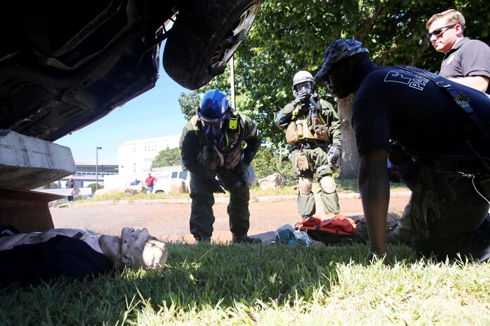 Corpsmen with Chemical Biological Incident Response Force, CBIRF, assess and attend to simulated casualties of a notional steam plant explosion as part of a final training exercise with Fire Department of New York, FDNY, on Randall’s Island, N.Y., Sept. 15, 2016. CBIRF’s Marines and sailors participated in a training event that included three days of lane training with FDNY instructors teaching classes in vehicle extrication, breaching, rope rescue and medical as part of urban rescue operations, and a final training operation in which CBIRF responded to a notional steam plant explosion. (Official U.S. Marine Corps photo by Lance Cpl. Maverick S. Mejia/RELEASED)
