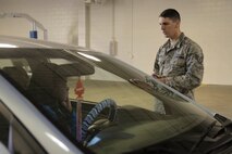 Staff Sgt. Chad Berry, 5th Logistics Readiness Squadron vehicle maintenance technician , speaks with a customer during a personal vehicle inspection at Minot Air Force Base, N.D., Oct. 7, 2016. Airmen checked fluids, tires and headlights to ensure customer vehicles were in proper working condition for the upcoming winter. (U.S. Air Force photo/Airman 1st Class Jessica Weissman)