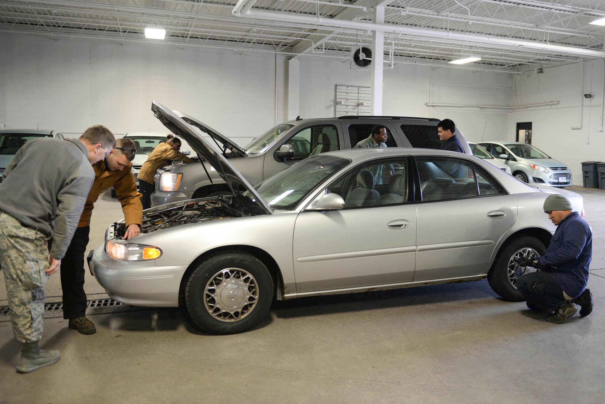 Airmen from the 5th Logistics Readiness Squadron vehicle maintenance section check personal vehicles during a free inspection at Minot Air Force Base, N.D., Oct. 7, 2016. Airmen ensured quality control for personal vehicles and explained the importance of winter car care. (U.S. Air Force photo/Airman 1st Class Jessica Weissman)