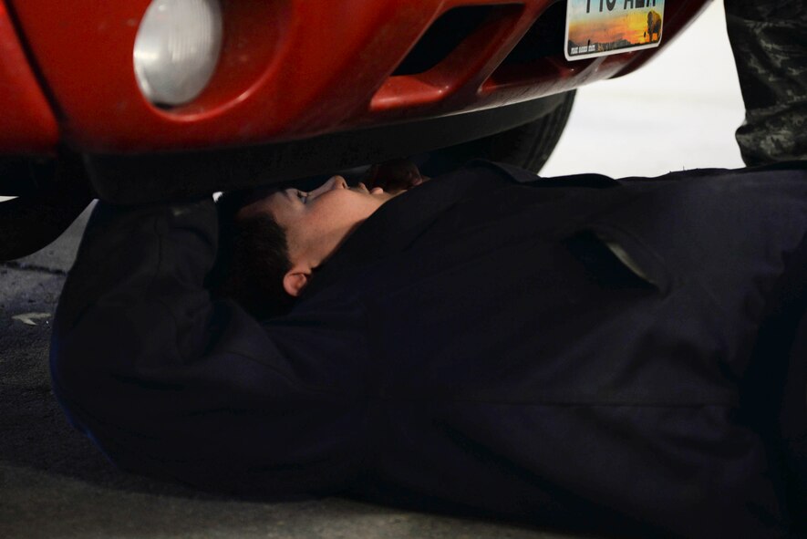 Airman 1st Class Sherman McVay, 5th Logistics Readiness Squadron vehicle maintenance technician, inspects a vehicle at Minot Air Force Base, N.D., Oct. 7, 2016. Airmen focused the inspection on helping spouses of deployed Airmen winterize their vehicles. (U.S. Air Force photo/Airman 1st Class Jessica Weissman)