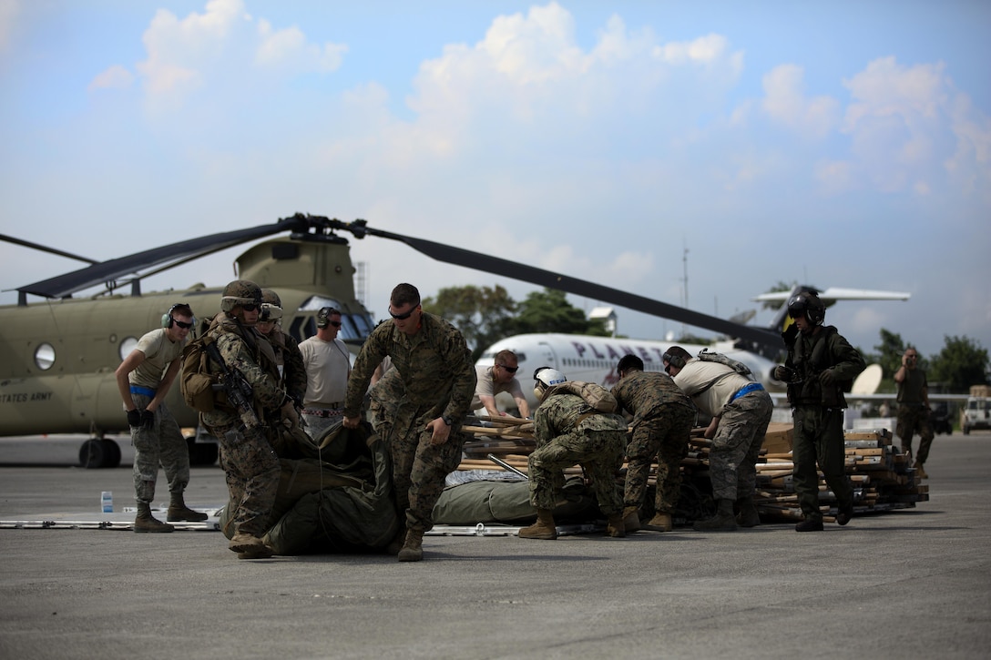 U.S. military members load relief supplies onto a CH-53E super stallion helicopter during a disaster relief mission at Port-au-Prince, Haiti, Oct. 10, 2016. The 24th MEU is part of a larger U.S. response to the government of Haiti request for humanitarian assistance. The U.S. effort is coordinated by the Department of State and the U.S. Agency for International Development. (U.S. Marine Corps photo by Lance Cpl. Melanye E. Martinez)
