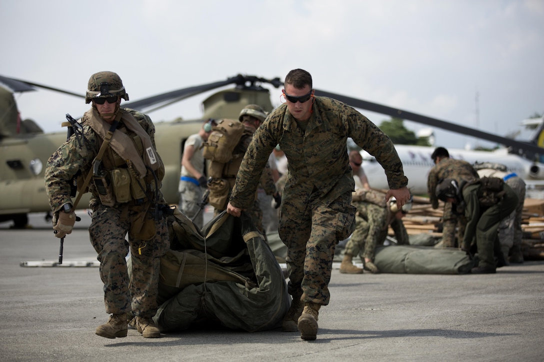 U.S. Marines with the 24th Marine Expeditionary Unit (24th MEU), load relief supplies to a CH-53E super stallion helicopter during a disaster relief mission at Port-au-Prince, Haiti, Oct. 10, 2016. The 24th MEU is part of a larger U.S. response to the government of Haiti request for humanitarian assistance. The U.S. effort is coordinated by the Department of State and the U.S. Agency for International Development. (U.S. Marine Corps photo by Lance Cpl. Melanye E. Martinez)