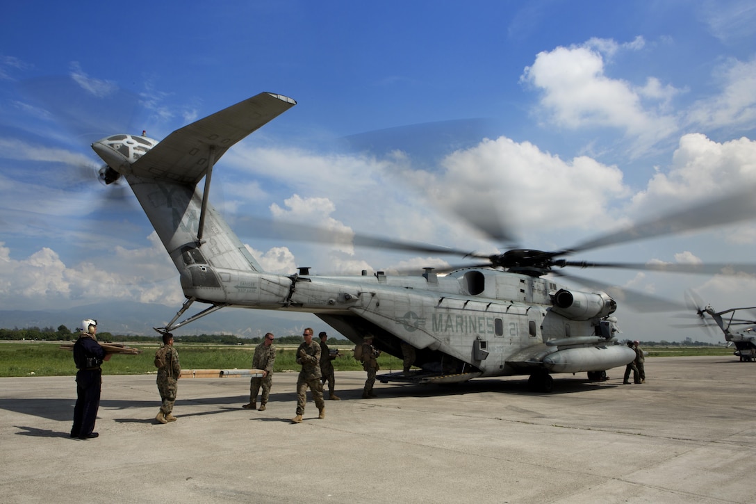 U.S. military members load relief supplies onto a CH-53E super stallion helicopter during a disaster relief mission at Port-au-Prince, Haiti, Oct. 10, 2016. The 24th MEU is part of a larger U.S. response to the government of Haiti request for humanitarian assistance. The U.S. effort is coordinated by the Department of State and the U.S. Agency for International Development. (U.S. Marine Corps photo by Lance Cpl. Melanye E. Martinez)