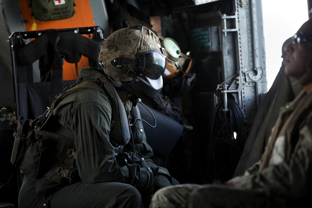 A U.S. Marine with Marine Medium Tiltrotor Squadron 365, 24th Marine Expeditionary Unit (24th MEU), looks out from a CH-53E super stallion helicopter during a disaster relief mission at Port-au-Prince, Haiti, Oct. 10, 2016. The 24th MEU is part of a larger U.S. response to the government of Haiti request for humanitarian assistance. The U.S. effort is coordinated by the Department of State and the U.S. Agency for International Development. (U.S. Marine Corps photo by Lance Cpl. Melanye E. Martinez)