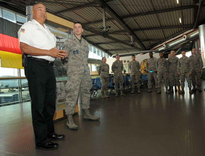 Tony Rabonza, 86th Civil Engineer Squadron Fire Emergency Services chief, talks about the deeds of Senior Airman Corey French, 721st Aerial Port Squadron passenger service agent, that led to the extinguishing a fire in base housing at Ramstein Air Base, Germany, Oct. 5, 2016. Due to French’s quick actions, Rabonza said the fire department was able to avoid hours of work fighting and ensuring a fire was completely out. (U.S. Air Force photo by Staff Sgt. Timothy Moore)