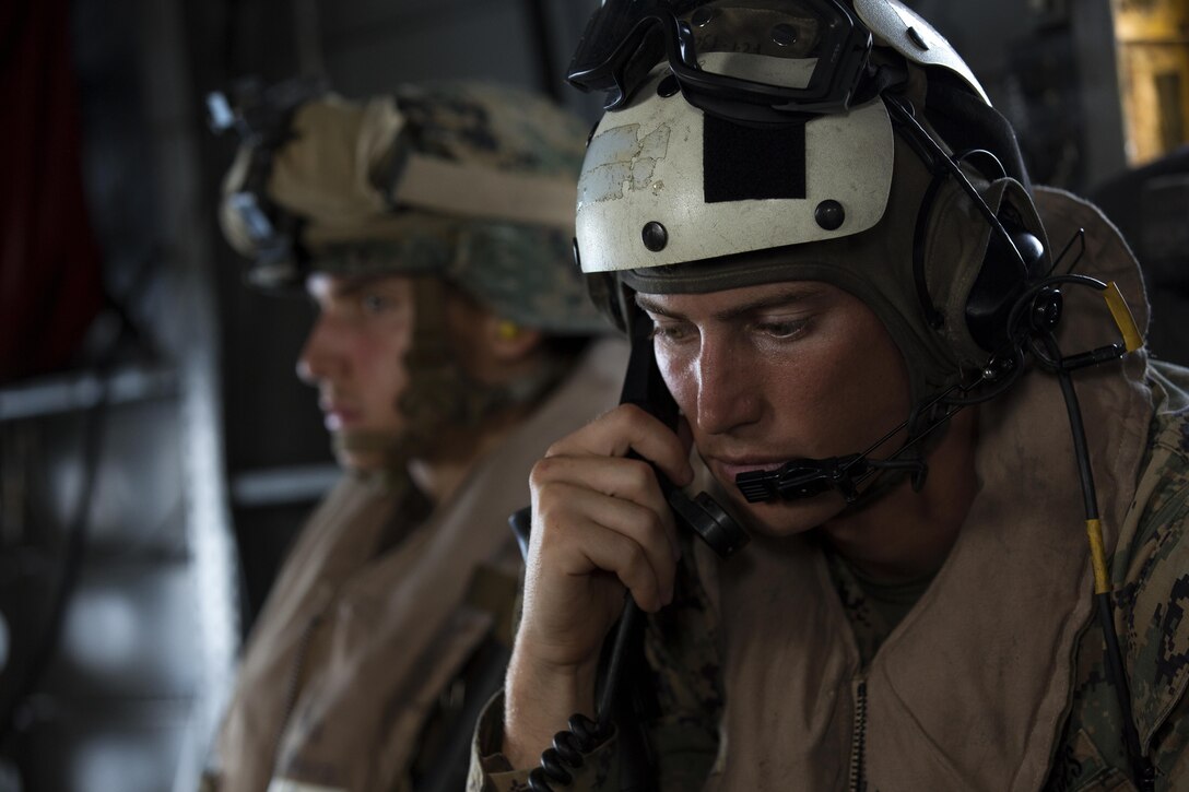 A U.S. Marine with the 24th Marine Expeditionary Unit (24th MEU), checks communications while riding in a CH-53E super stallion helicopter during a disaster relief mission at Port-au-Prince, Haiti, Oct. 10, 2016. The 24th MEU is part of a larger U.S. response to the government of Haiti request for humanitarian assistance. The U.S. effort is coordinated by the Department of State and the U.S. Agency for International Development. (U.S. Marine Corps photo by Lance Cpl. Melanye E. Martinez)