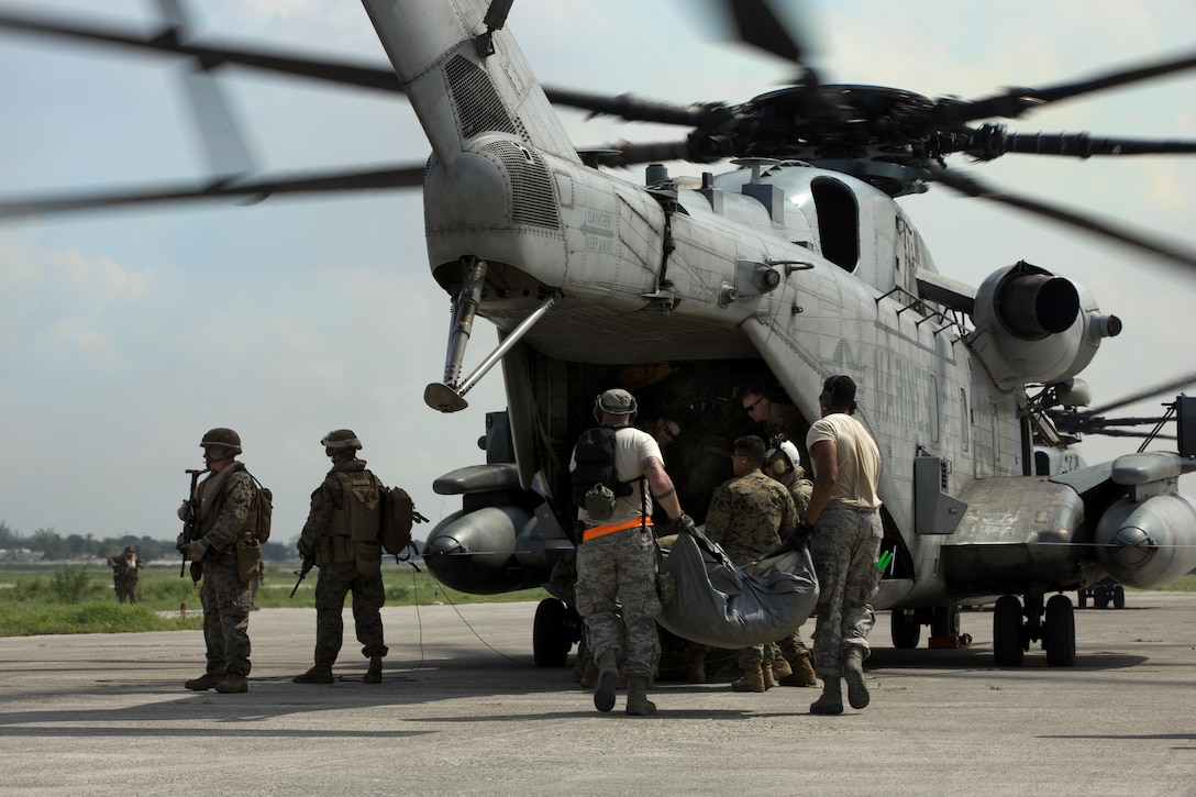 U.S. military members load relief supplies onto a CH-53E super stallion helicopter during a disaster relief mission at Port-au-Prince, Haiti, Oct. 10, 2016. The 24th MEU is part of a larger U.S. response to the government of Haiti request for humanitarian assistance. The U.S. effort is coordinated by the Department of State and the U.S. Agency for International Development. (U.S. Marine Corps photo by Lance Cpl. Melanye E. Martinez)