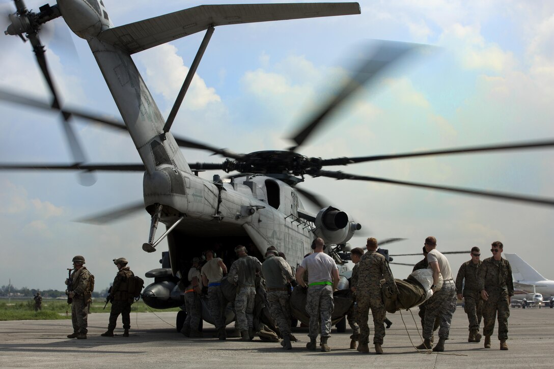 U.S. military members load relief supplies onto a CH-53E super stallion helicopter during a disaster relief mission at Port-au-Prince, Haiti, Oct. 10, 2016. The 24th MEU is part of a larger U.S. response to the government of Haiti request for humanitarian assistance. The U.S. effort is coordinated by the Department of State and the U.S. Agency for International Development. (U.S. Marine Corps photo by Lance Cpl. Melanye E. Martinez)