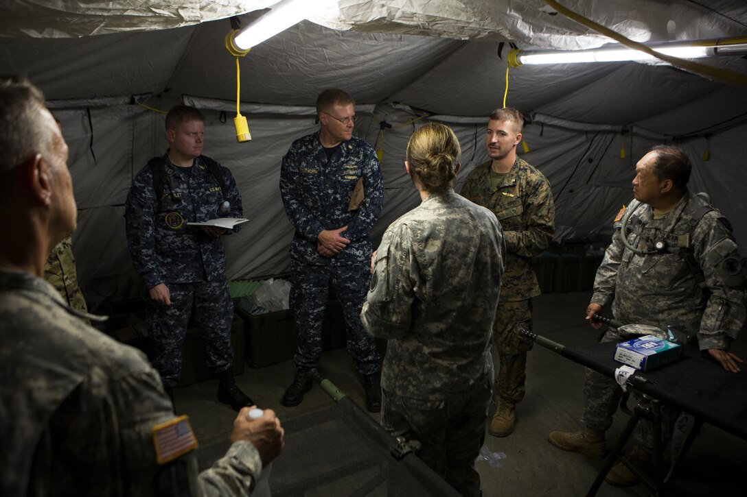 U.S. military medical personnel discuss medical capabilities at Port-au-Prince, Haiti, Oct. 10, 2016. The United States military is currently providing humanitarian relief assistance in Haiti because of the aftermath of Hurricane Matthew. (U.S. Marine Corps photo by Lance Cpl. Melanye E. Martinez)