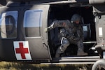 A member of Company C, 1st Battalion, 189th
Aviation Regiment, South Dakota Army National Guard, closes the door
after loading a patient onto a HH-60M Black Hawk helicopter during a
medical evacuation training event near Wasta, S.D., Oct. 1, 2016. Soldiers
simulated injuries in order to give the medics a realistic training opportunity.
