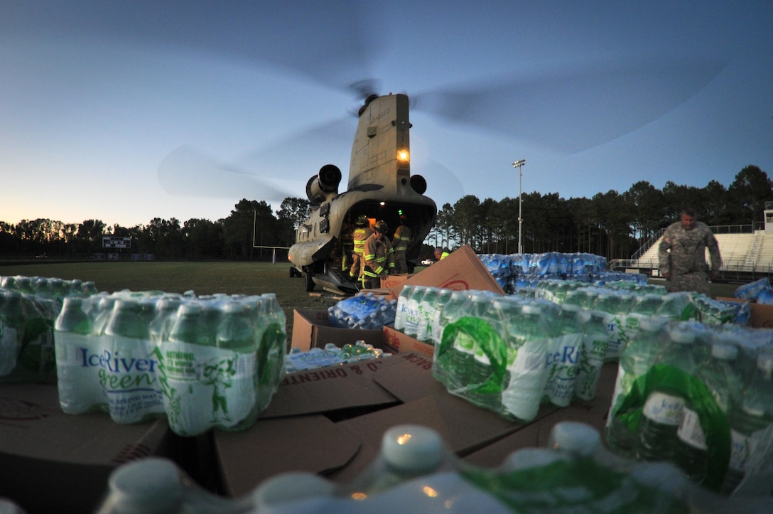 A South Carolina National Guard’s CH-47F Chinook helicopter assigned lands at the Whale Branch Early College High School and delivers water and food supplies to the community of Seabrook in the aftermath of Hurricane Matthew Oct. 9. DLA Troop Support provided meals for 6,000 Marine recruits who were evacuated before the storm from Paris Island, South Carolina to Albany, Georgia. Hurricane Matthew peaked as a Category 4 hurricane in the Caribbean and hit the S.C. coast on Oct. 7. 