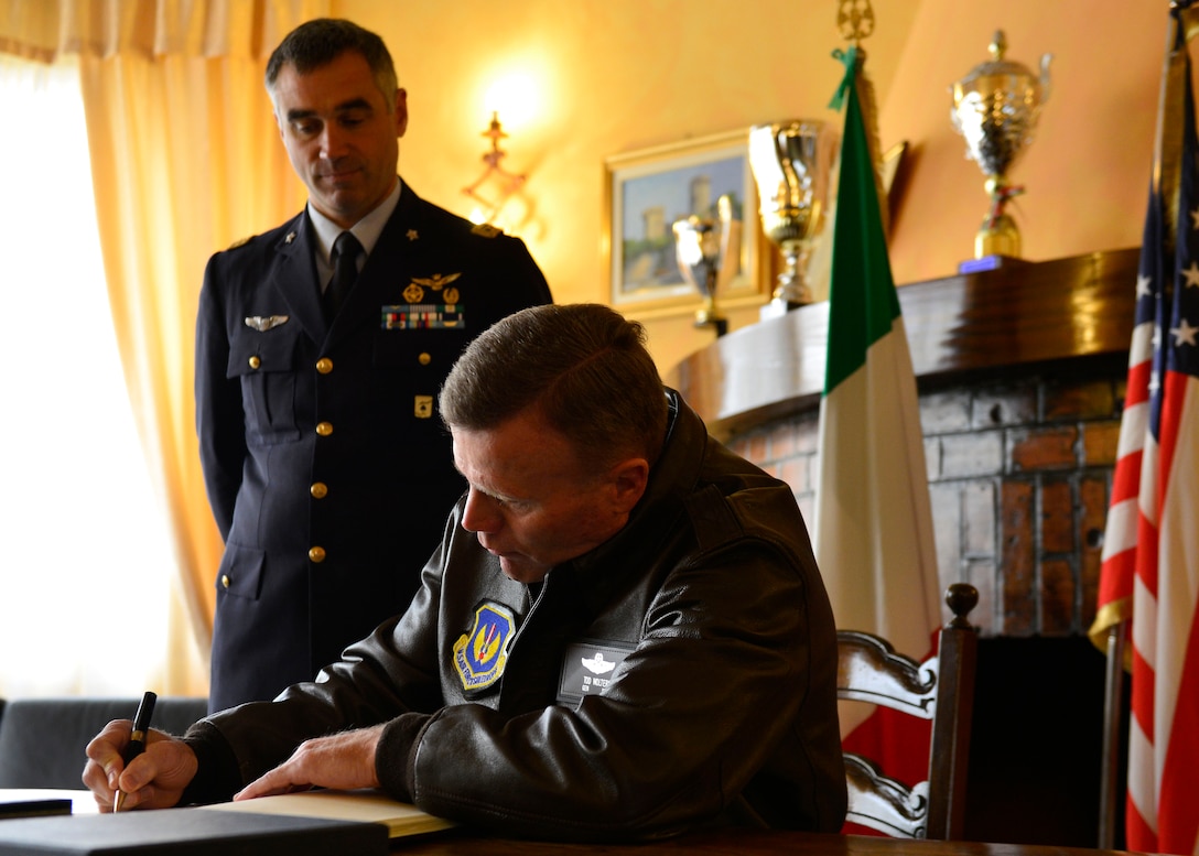 Gen. Tod D. Wolters, U.S. Air Forces in Europe - Air Forces Africa commander, signs the Italian guestbook during his visit at Aviano Air Base, Italy on Oct. 13, 2016. This was Wolters first visit to the base since assuming command of USAFE-AFAFRICA in August. (U.S. Air Force photo by Airman 1st Class Cary Smith/Released)