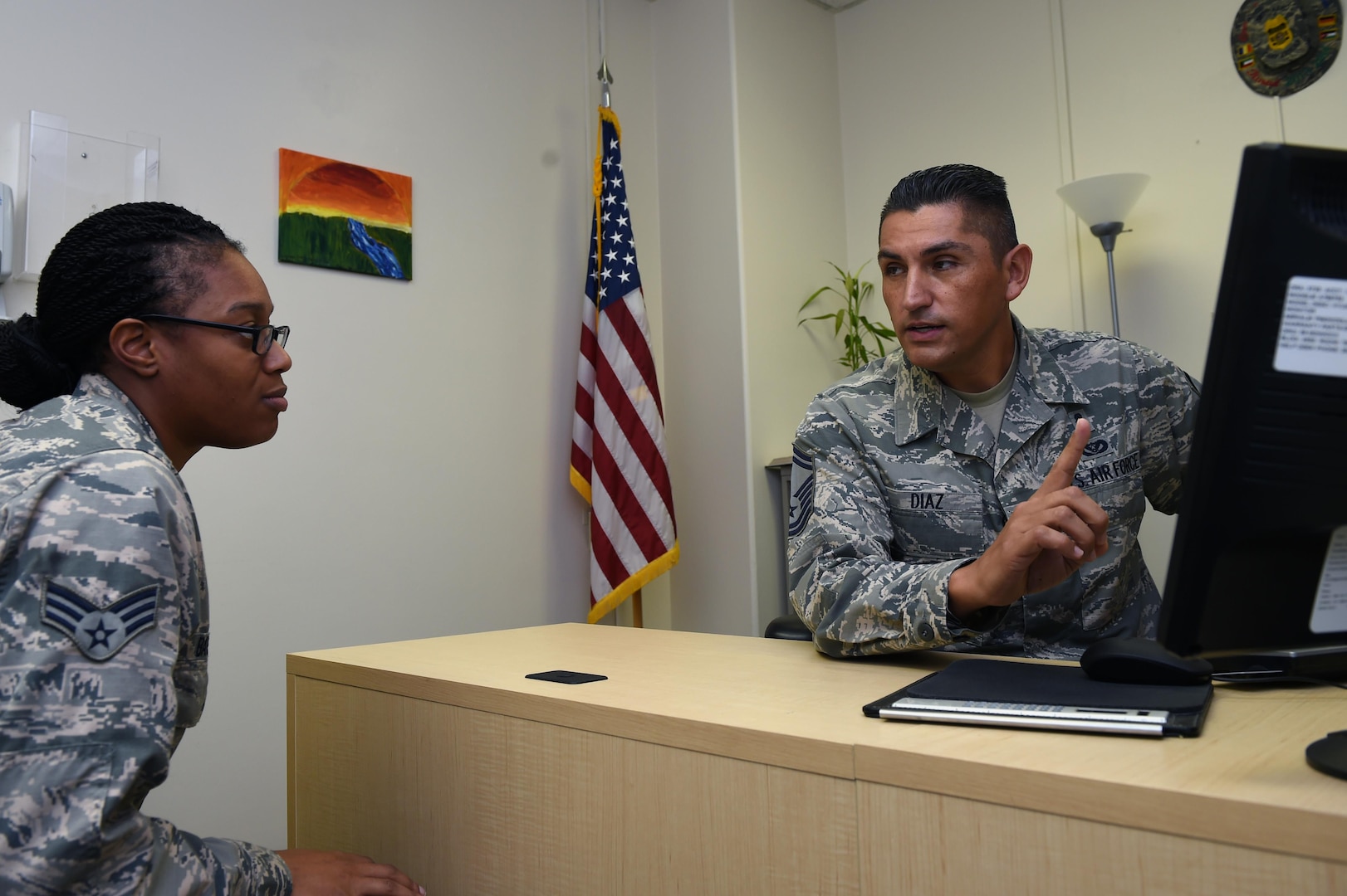 Senior Master Sgt. Jose Diaz helps Senior Airman Laketa Baisden, a medical technician with the 559th Aerospace Medicine Squadron, with career advice Sept. 19 at the Wilford Hall Ambulatory Surgical Center, Joint Base San Antonio-Lackland, Texas. Diaz, who is the 59th Medical Wing career assistance advisor and one of four Joint Base San Antonio career advisors, helps Airmen by providing information on benefits and programs the Air Force has to offer. (U.S. Air Force photo/Staff Sgt. Jason Huddleston)