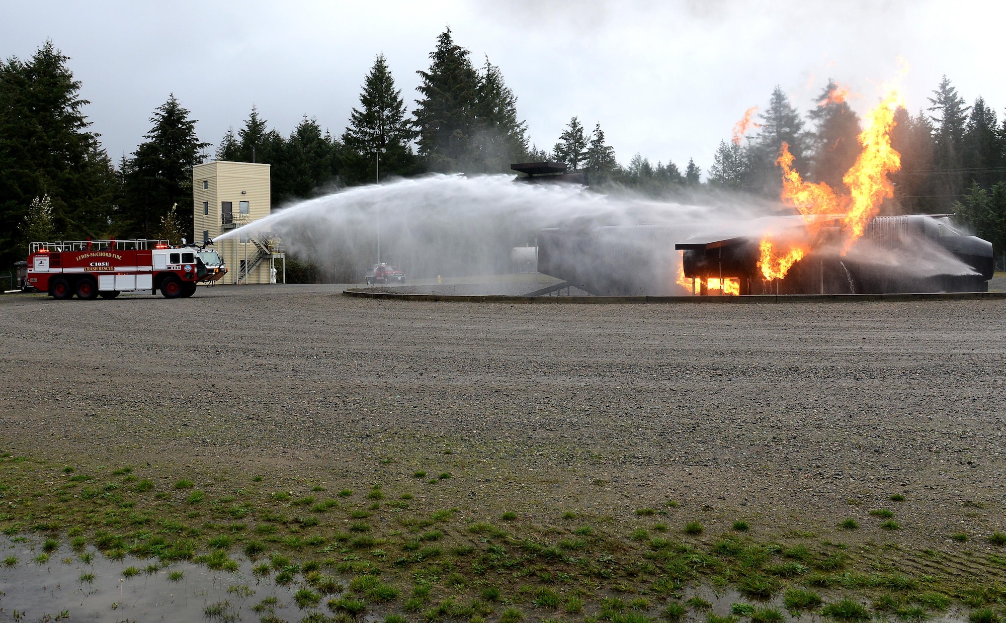 A McChord fire truck puts out a simulated aircraft fire during Ben Lambertson’s Pilot for a Day visit Oct. 7, 2016 at Joint Base Lewis-McChord, Wash. Ben was selected by the McChord Air Force Association as this month’s Pilot for a Day. (U.S. Air Force photo/Senior Airman Divine Cox)