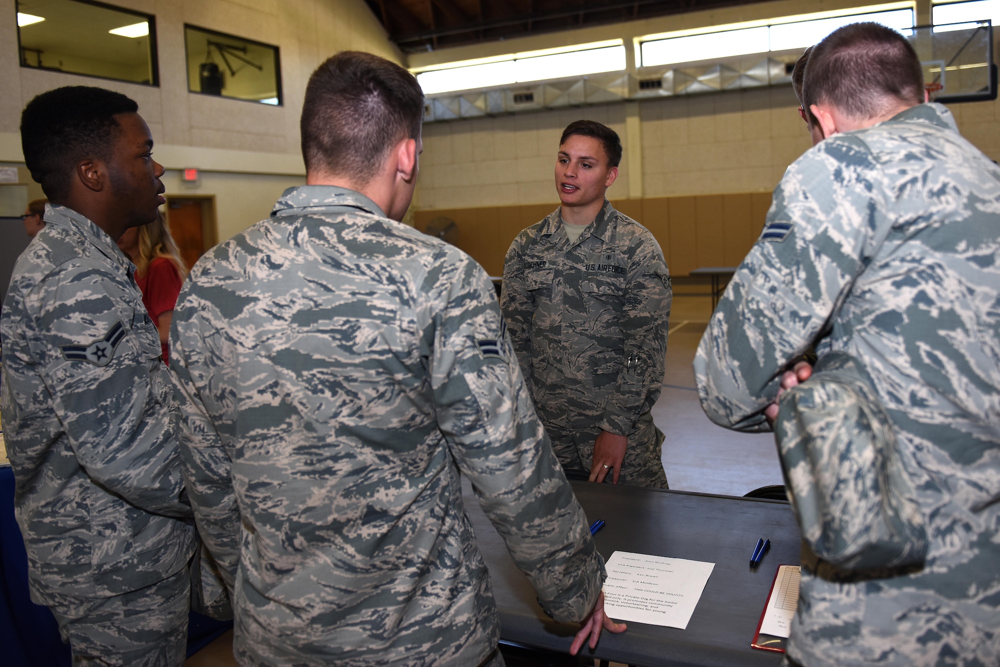 U.S. Air Force Airman Marcellio Kirchner, 17th Medical Operations Squadron records technician and First Four club president, speaks to Airmen during the Volunteer Fair at Carswell Fieldhouse on Goodfellow Air Force Base, Texas, Oct. 12, 2016. The First Four club is a volunteer association for all enlisted service members, E-4 and below. (U.S. Air Force photo by Airman 1st Class Caelynn Ferguson/Released)
