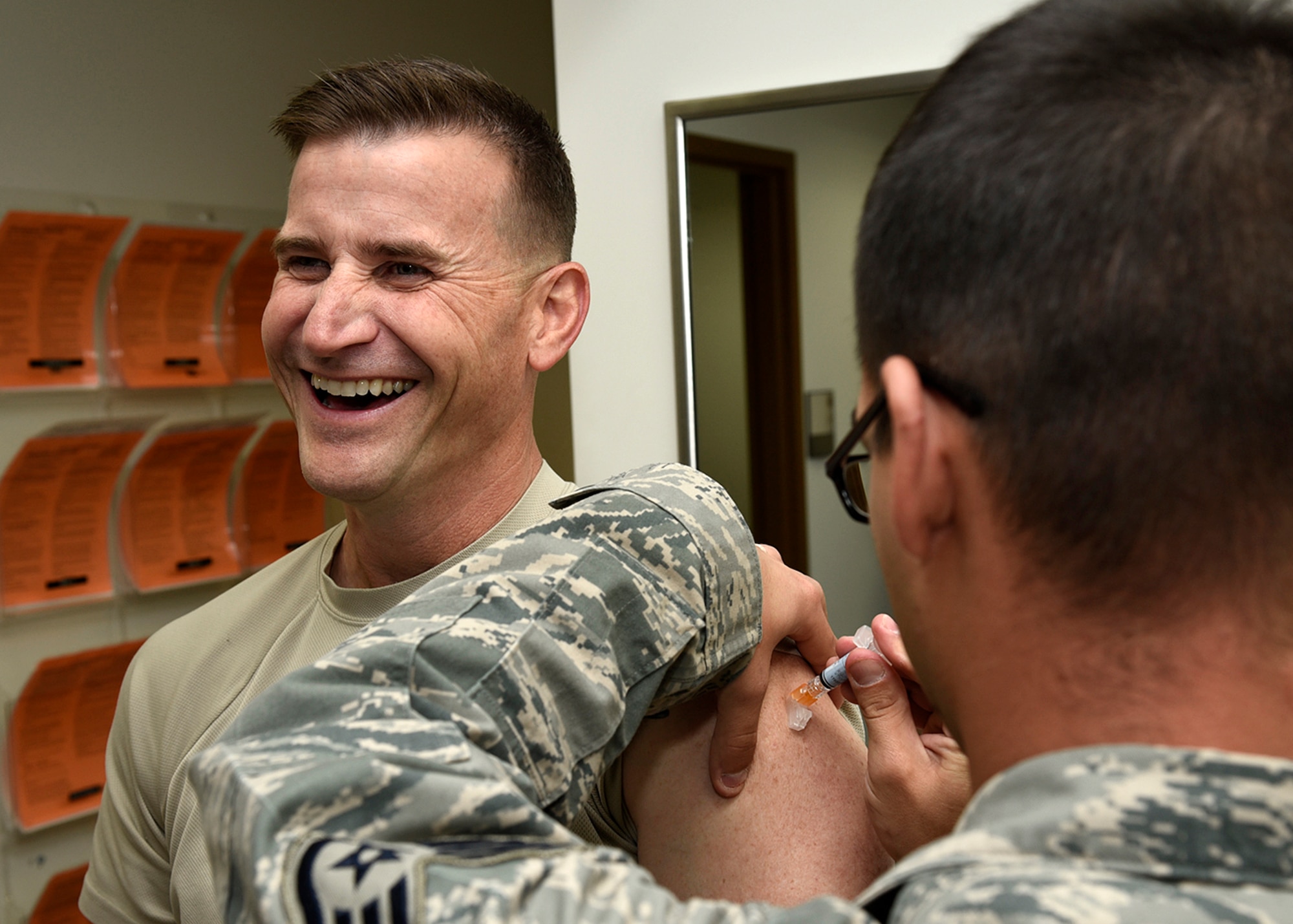 PETERSON AIR FORCE BASE, Colo. – Chief Master Sgt. Mark Bronson, 21st Space Wing command chief, smiles as he receives the flu shot at the immunizations clinic on Peterson Air Force Base, Colo., Oct. 13, 2016. A flu line will be available at the R.P. Lee Youth Center on Oct. 20 for all Tricare beneficiaries ages 3 and up. (U.S. Air Force photo by Senior Airman Rose Gudex)