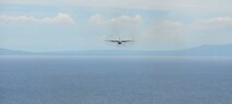 A U.S. Air Force C-130 Hercules participates in a low-cost, low-altitude bundle drop over the water near Cebu, Philippines, as part of the current iteration of a rotational Air Contingent at Brigadier General Benito N Ebuen Air Base, Lapu-Lapu City, Philippines, Oct. 5, 2016. For the exchange, C-130 aircraft from Yokota Air Base's 374th Airlift Wing flew with members of the Philippine Air Force's 220th Airlift Wing, from Brig. Gen. Benito N. Ebuen Air Base, Lapu-Lapu City, Philippines, and discussed the intricacies of LCLA bundle drops. Two Yokota-based C-130s, members of the 36th Contingency Response Group from Andersen Air Force Base, Guam, and other units from across U.S. Pacific Command conducted bilateral training missions and subject matter expert exchanges alongside their Philippine Air Force counterparts. The Air Contingent is helping build the capacity of the Philippine Air Force and increases joint training, promotes interoperability and provides greater and more transparent air and maritime situational awareness to ensure safety for military and civilian activities in international waters and airspace. Its missions include air and maritime domain awareness, personnel recovery, combating piracy, and assuring access to the air and maritime domains in accordance with international law. (U.S. Air Force photo by Capt. Mark Lazane)