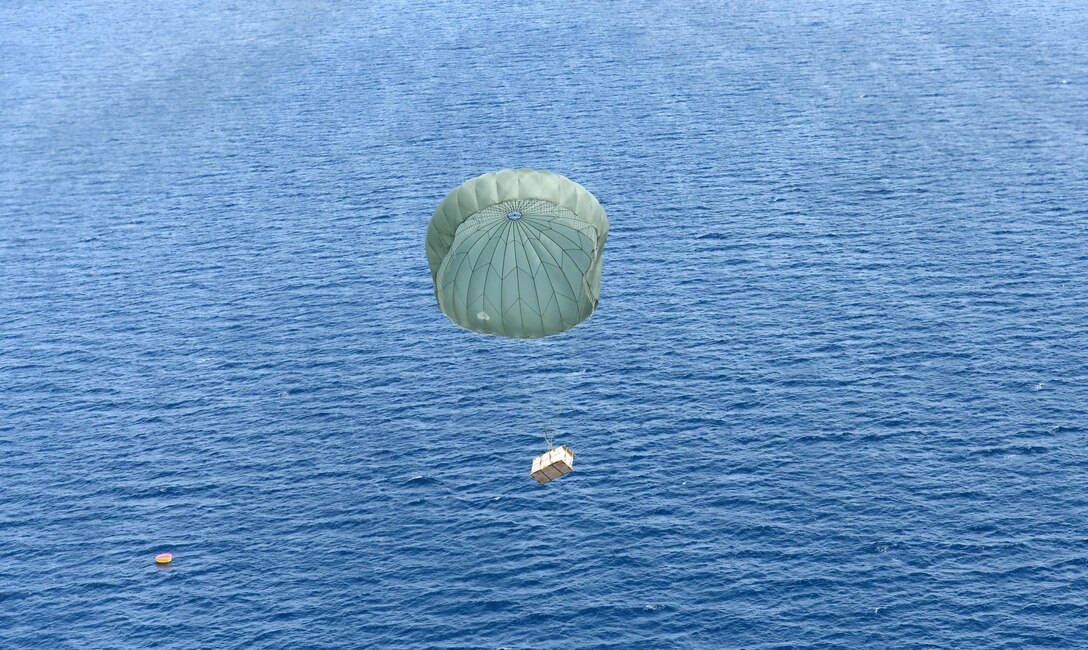 A low-cost, low-altitude bundle floats to the designated drop zone location in front of an approaching U.S. Air Force C-130 Hercules near Cebu, Philippines, as part of the current iteration of a rotational Air Contingent in the Philippines Oct. 5, 2016. For the exchange, C-130 Hercules aircraft and crews from Yokota Air Base's 374th Airlift Wing flew with members of the Philippine Air Force's 220th Airlift Wing, from Brig. Gen. Benito N. Ebuen Air Base, Lapu-Lapu City, Philippines, and discussed the intricacies of LCLA bundle drops. Two C-130s and crews from 374th Airlift Wing, Yokota Air Base, Japan, the 36th Contingency Response Group from Andersen Air Force Base, Guam, and other units from across U.S. Pacific Command conducted bilateral training missions and subject matter expert exchanges alongside their Philippine Air Force counterparts. The Air Contingent is helping build the capacity of the Philippine Air Force and increases joint training, promotes interoperability and provides greater and more transparent air and maritime situational awareness to ensure safety for military and civilian activities in international waters and airspace. Its missions include air and maritime domain awareness, personnel recovery, combating piracy, and assuring access to the air and maritime domains in accordance with international law. (U.S. Air Force photo by Capt. Mark Lazane)